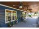 Inviting covered porch with furniture and ceiling fans at 106 Chatworth Ln, Mooresville, NC 28117