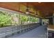 Expansive covered porch with ceiling fans, seating, and view of fenced-in backyard at 106 Chatworth Ln, Mooresville, NC 28117