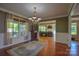 Elegant dining room with hardwood floors, chandelier, and backyard view at 106 Chatworth Ln, Mooresville, NC 28117