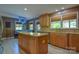 Spacious kitchen with a granite-topped island, custom cabinets, and adjacent dining area with banquette seating at 106 Chatworth Ln, Mooresville, NC 28117