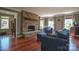Bright living room boasting a stone fireplace, hardwood floors, and comfortable seating at 106 Chatworth Ln, Mooresville, NC 28117