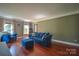 Inviting living room with hardwood floors, large windows, and comfortable blue seating at 106 Chatworth Ln, Mooresville, NC 28117
