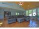 Comfortable living room featuring a large sectional sofa and unique wood flooring at 106 Chatworth Ln, Mooresville, NC 28117
