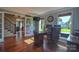 Spacious home office featuring hardwood floors, a large desk, and bright natural light at 106 Chatworth Ln, Mooresville, NC 28117