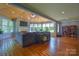 Large sunroom with vaulted ceilings, hardwood floors, and multiple windows, great for relaxing at 106 Chatworth Ln, Mooresville, NC 28117
