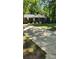 Brick home with walkway, white rocking chairs, driveway, and mature landscaping at 10624 Wood Meadow Dr, Charlotte, NC 28227