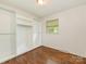 Bedroom with hardwood floors, a window, and a closet with built-in shelving at 1100 Clawson Ct, Charlotte, NC 28209