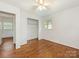 Bright bedroom features hardwood floors, a ceiling fan, and a spacious closet for ample storage at 1100 Clawson Ct, Charlotte, NC 28209