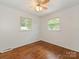 Bright bedroom with hardwood floors, a ceiling fan, and two windows at 1100 Clawson Ct, Charlotte, NC 28209
