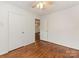 Bedroom featuring hardwood floors and connecting hallway at 1100 Clawson Ct, Charlotte, NC 28209