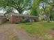 Charming single-story brick house with well-kept lawn and landscaping at 1100 Clawson Ct, Charlotte, NC 28209