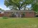 Charming single-story brick home with a well-maintained lawn and inviting front entrance at 1100 Clawson Ct, Charlotte, NC 28209