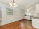 Bright eat-in kitchen featuring hardwood floors, white cabinets, and stainless steel refrigerator at 1100 Clawson Ct, Charlotte, NC 28209