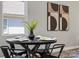 Eat-in kitchen with dark table and chairs near a window, accented by geometric art at 1101 Kenly St, Salisbury, NC 28144