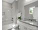 Well-lit bathroom features a granite countertop, shower-tub combo and marble-tiled walls at 1103 Kenly St, Salisbury, NC 28144
