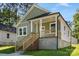 Charming home with a cozy front porch and light green siding at 1103 Kenly St, Salisbury, NC 28144