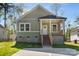 Charming home with a cozy front porch and light green siding at 1103 Kenly St, Salisbury, NC 28144