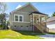 Charming home with a cozy front porch and light green siding at 1103 Kenly St, Salisbury, NC 28144