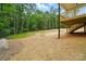 View of the landscaped back yard featuring mature trees and wood supports at 1118 Allman Ext, Mount Pleasant, NC 28124
