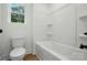 Bathroom featuring a shower and bath with tub and toilet with storage at 1118 Allman Ext, Mount Pleasant, NC 28124