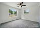 Bedroom featuring neutral colored carpet, two windows with lots of natural light and ceiling fan at 1118 Allman Ext, Mount Pleasant, NC 28124
