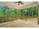 Wood deck featuring wood railing and ceiling fan overlooking a beautiful wooded area at 1118 Allman Ext, Mount Pleasant, NC 28124