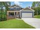 Charming two-story home with blue siding, a two-car garage, and a welcoming front porch at 1118 Allman Ext, Mount Pleasant, NC 28124