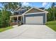 Charming two-story home with blue siding, a two-car garage, and a welcoming front porch at 1118 Allman Ext, Mount Pleasant, NC 28124