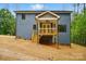 Back exterior of house with wood deck with access to yard and stairs to yard at 1118 Allman Ext, Mount Pleasant, NC 28124