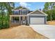 Charming two-story home featuring a brick porch, blue siding, and attached two car garage at 1118 Allman Ext, Mount Pleasant, NC 28124
