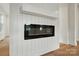 Close-up of a modern electric fireplace with a white mantel and shiplap surround at 1118 Allman Ext, Mount Pleasant, NC 28124