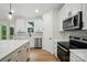 Modern kitchen with stainless appliances, stone countertops, and bright white cabinets at 1118 Allman Ext, Mount Pleasant, NC 28124