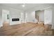 Bright living room featuring wood flooring, an electric fireplace, and staircase access at 1118 Allman Ext, Mount Pleasant, NC 28124