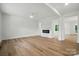 Spacious living room with a modern fireplace, wood flooring, and plenty of natural light at 1118 Allman Ext, Mount Pleasant, NC 28124