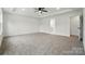 Spacious main bedroom boasts tray ceilings, fan, and an ensuite bathroom, providing comfort and style at 1118 Allman Ext, Mount Pleasant, NC 28124