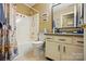 Well-lit bathroom featuring a shower and tub combination and vanity with framed mirror at 118 Winborne Dr, Mooresville, NC 28115