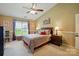 Comfortable bedroom with ceiling fan, large window, and cozy furnishings at 118 Winborne Dr, Mooresville, NC 28115