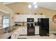 Bright kitchen with white cabinets, black appliances, and neutral countertops at 118 Winborne Dr, Mooresville, NC 28115