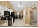 Open kitchen and dining area features white cabinets and modern black appliances, perfect for entertaining at 118 Winborne Dr, Mooresville, NC 28115