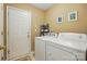 Functional laundry room with a washer and dryer, a door to the outside, and room for storage at 118 Winborne Dr, Mooresville, NC 28115