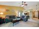 Cozy living room with vaulted ceiling, neutral carpet, and kitchen view at 118 Winborne Dr, Mooresville, NC 28115