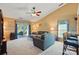 Cozy living room with vaulted ceilings, comfortable seating, and sliding door access to outdoor patio at 118 Winborne Dr, Mooresville, NC 28115