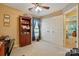 Bright office space featuring a wooden desk and bookshelf with natural light, and double closets at 118 Winborne Dr, Mooresville, NC 28115