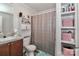 Cozy bathroom showcasing a single sink vanity, shower-tub combination, and built in shelving at 119 Marietta Rd, Mooresville, NC 28117