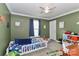 bedroom with green walls, white trim, a ceiling fan and carpet at 119 Marietta Rd, Mooresville, NC 28117