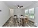 Bright dining area with wood floors, ceiling fan, and natural light from large windows at 119 Marietta Rd, Mooresville, NC 28117