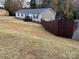 Exterior of a single-story home featuring a manicured lawn and a stained wood fence at 119 Marietta Rd, Mooresville, NC 28117