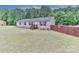 Comfortable home with neat yard and a wooden fence providing privacy, creating a cozy outdoor space at 119 Marietta Rd, Mooresville, NC 28117