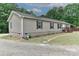 Side view of a home with landscaping, a well-kept lawn, gravel drive, and a tidy, welcoming exterior at 119 Marietta Rd, Mooresville, NC 28117