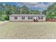 Charming single-story home with a well-maintained lawn, complemented by a backdrop of lush greenery at 119 Marietta Rd, Mooresville, NC 28117